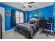 Bedroom featuring blue walls, carpeted floors, and a ceiling fan at 5462 S Crest Ridge S Dr, Ellenwood, GA 30294