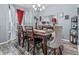 Elegant dining room featuring a stylish table setting, hardwood floors, modern decor, and ample natural light at 5462 S Crest Ridge S Dr, Ellenwood, GA 30294