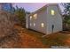 Two-story home showcasing light gray siding, green grass, and a wooded backdrop at dusk at 5462 S Crest Ridge S Dr, Ellenwood, GA 30294