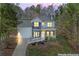 Inviting two-story home featuring stone accents, white siding, a charming front porch, and a well-manicured lawn at 5462 S Crest Ridge S Dr, Ellenwood, GA 30294