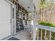 Charming front porch featuring rocking chairs and stylish decor, perfect for relaxing and enjoying the outdoors at 5462 S Crest Ridge S Dr, Ellenwood, GA 30294
