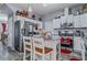 Well-appointed kitchen featuring white cabinets, stainless steel appliances, granite countertops, and an island with seating at 5462 S Crest Ridge S Dr, Ellenwood, GA 30294