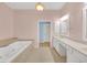 The spacious bathroom features a soaking tub, dual sinks and leads to the bedroom at 6206 Carriage Gate Se Ln # 6, Mableton, GA 30126
