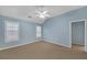 Spacious bedroom features neutral carpet, a ceiling fan, bright natural light and cool blue walls at 6206 Carriage Gate Se Ln # 6, Mableton, GA 30126