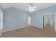 The airy bedroom boasts a ceiling fan and neutral carpet, with views leading to an attached bathroom at 6206 Carriage Gate Se Ln # 6, Mableton, GA 30126