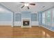 Bright living room with fireplace, built-ins, hardwood floors, and plentiful natural light from large windows at 6206 Carriage Gate Se Ln # 6, Mableton, GA 30126