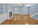 Open concept living room showcasing fireplace with built-ins, hardwood floors, and staircase at 6206 Carriage Gate Se Ln # 6, Mableton, GA 30126