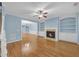 Cozy living room featuring hardwood floors, fireplace with built-in shelving, and stylish ceiling fan at 6206 Carriage Gate Se Ln # 6, Mableton, GA 30126