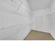 This walk-in closet offers ample storage with shelving and a neutral carpet floor at 6206 Carriage Gate Se Ln # 6, Mableton, GA 30126