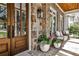 Inviting front porch featuring stone accents, an outdoor seating area, and a warm, welcoming entrance at 156 Lake Forrest Ne Ln, Atlanta, GA 30342