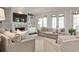 Bright living room with built-in shelves, fireplace, neutral furniture, and large windows at 156 Lake Forrest Ne Ln, Atlanta, GA 30342