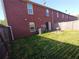 The backyard of this townhouse features grass, a patio, and a privacy fence at 6016 Creekerton Blvd, Mcdonough, GA 30252