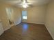 This bedroom features wood-look floors and a window letting in natural light at 6016 Creekerton Blvd, Mcdonough, GA 30252