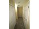 Hallway with neutral carpet, white doors, and access to multiple rooms at 6016 Creekerton Blvd, Mcdonough, GA 30252