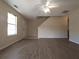 Bright living room with fresh paint, modern ceiling fan, and wood-look floors at 6016 Creekerton Blvd, Mcdonough, GA 30252