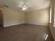 Spacious living room featuring wood-look flooring, ceiling fan, and lots of space at 6016 Creekerton Blvd, Mcdonough, GA 30252