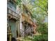 Exterior view of the house shows multi-level balconies, and wooden stairs at 6991 Flagstone Dr, Austell, GA 30168