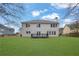 Home's backyard features a lush lawn, a cozy deck and ample space for relaxation and outdoor entertainment at 9429 Golfview Pt, Villa Rica, GA 30180