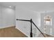 Light-filled foyer boasts a large window and decorative staircase at 9429 Golfview Pt, Villa Rica, GA 30180