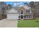 Beautiful two-story home featuring stone accents, a manicured lawn, and a two-car garage at 9429 Golfview Pt, Villa Rica, GA 30180
