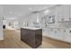 Open-concept kitchen with a dark island, white cabinets, quartz countertops, and stainless appliances at 9429 Golfview Pt, Villa Rica, GA 30180