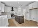 Bright kitchen features stainless steel appliances, central island and white cabinets at 9429 Golfview Pt, Villa Rica, GA 30180