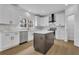 Bright kitchen features stainless steel appliances, central island and white cabinets at 9429 Golfview Pt, Villa Rica, GA 30180
