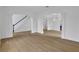 Open-concept living area featuring wainscoting, light floors, and archways to other rooms at 9429 Golfview Pt, Villa Rica, GA 30180