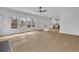 Open-concept living room with fireplace and access to kitchen and outdoor living at 9429 Golfview Pt, Villa Rica, GA 30180
