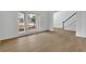 Bright living room with wainscoting, light floors, a large window, and archway to other rooms at 9429 Golfview Pt, Villa Rica, GA 30180