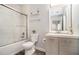 Modern bathroom with shower-tub combo, vanity, and decorative mirror at 955 Juniper St # 3026, Atlanta, GA 30309
