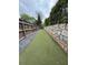 Fenced dog run with artificial turf and stone wall, offering a secure area for pet exercise at 955 Juniper St # 3026, Atlanta, GA 30309