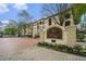 Attractive multi-story condo community, Tuscany Condominiums, featuring well-maintained landscaping and brick paved driveway at 955 Juniper St # 3026, Atlanta, GA 30309