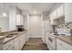 Galley kitchen with stainless steel appliances, white cabinetry, and stylish backsplash at 955 Juniper St # 3026, Atlanta, GA 30309