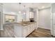Kitchen view featuring breakfast bar that opens to living area, white cabinets, and wood flooring at 955 Juniper St # 3026, Atlanta, GA 30309