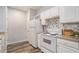 Kitchen featuring white appliances, tiled backsplash, and modern cabinets at 955 Juniper St # 3026, Atlanta, GA 30309