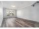 Open living room with large window and hardwood floors and tv wall mount at 955 Juniper St # 3026, Atlanta, GA 30309