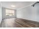 Open living room with large window and hardwood floors and tv wall mount at 955 Juniper St # 3026, Atlanta, GA 30309