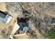 The aerial view shows the mature trees surrounding this home and a long driveway to the house at 9600 Poplar Ct, Douglasville, GA 30135