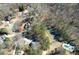 Overhead view of neighborhood with mature trees, homes, and tennis court at 9600 Poplar Ct, Douglasville, GA 30135