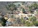 The aerial view shows the neighborhood is nestled in a mature hardwood forest near the lake at 9600 Poplar Ct, Douglasville, GA 30135