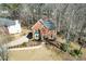 Aerial view of a red brick home with a well-manicured yard and mature trees at 9600 Poplar Ct, Douglasville, GA 30135