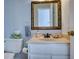 Bathroom with white vanity, mirror, and toilet at 9600 Poplar Ct, Douglasville, GA 30135