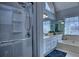 Bright bathroom featuring a tiled shower, soaking tub, and double vanity with decorative lighting at 9600 Poplar Ct, Douglasville, GA 30135