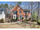 Charming brick home featuring a well-manicured front yard and lush green landscaping at 9600 Poplar Ct, Douglasville, GA 30135