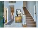 Inviting foyer with staircase, light gray walls, neutral tile floors, and wood accents at 9600 Poplar Ct, Douglasville, GA 30135