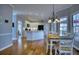 Open kitchen and dining area with white cabinets and hardwood floors at 9600 Poplar Ct, Douglasville, GA 30135