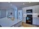 Well-lit kitchen featuring modern appliances, white cabinets, and light-colored countertops at 9600 Poplar Ct, Douglasville, GA 30135