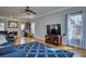 Bright living room with hardwood floors, large windows, and a cozy fireplace at 9600 Poplar Ct, Douglasville, GA 30135