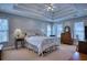 Spacious main bedroom with tray ceiling and multiple windows at 9600 Poplar Ct, Douglasville, GA 30135
